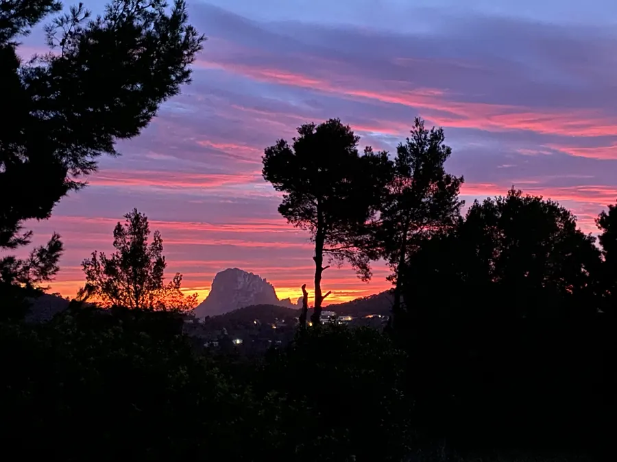 Es Vedrà silhouette under a pink sky